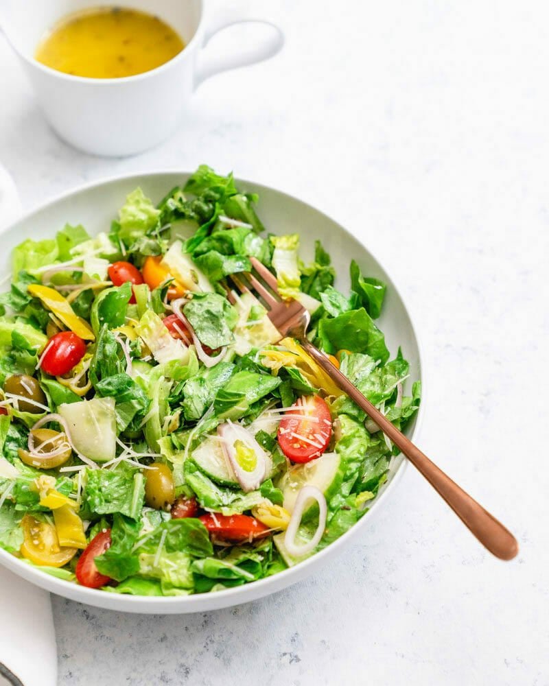Chopped salad in white bowl with Italian dressing