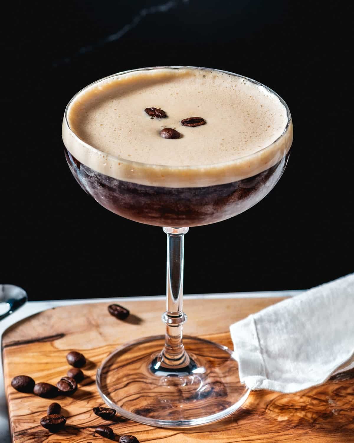 Espresso Martini in cocktail glass topped with 3 coffee beans