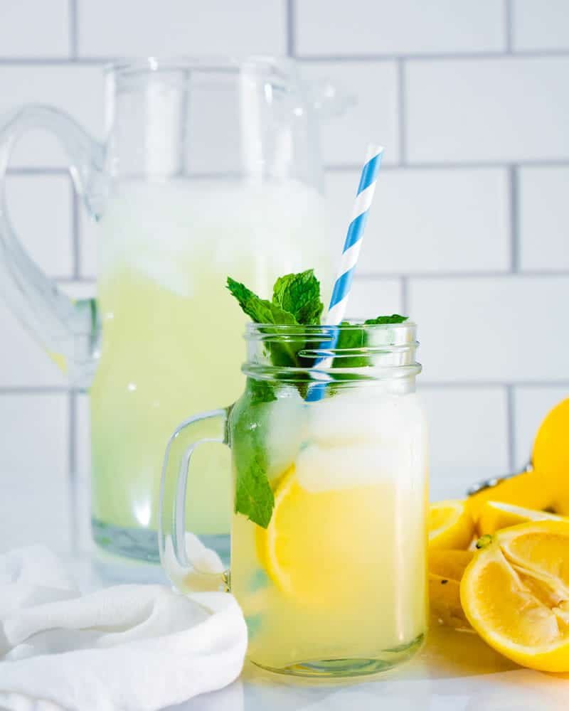 Lemonade recipes: lemonade in jar with straw and mint. 