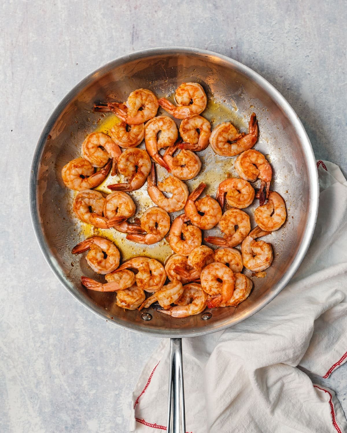 Overhead view of shrimp completely cooked in a frying pan