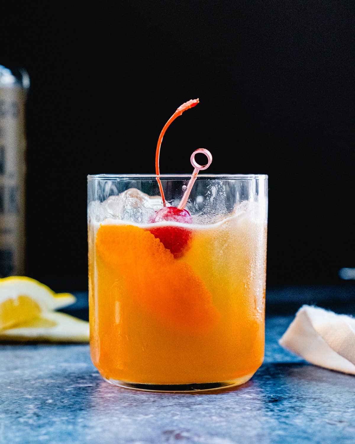 Whiskey Sour recipe in cocktail glass with cherry. 